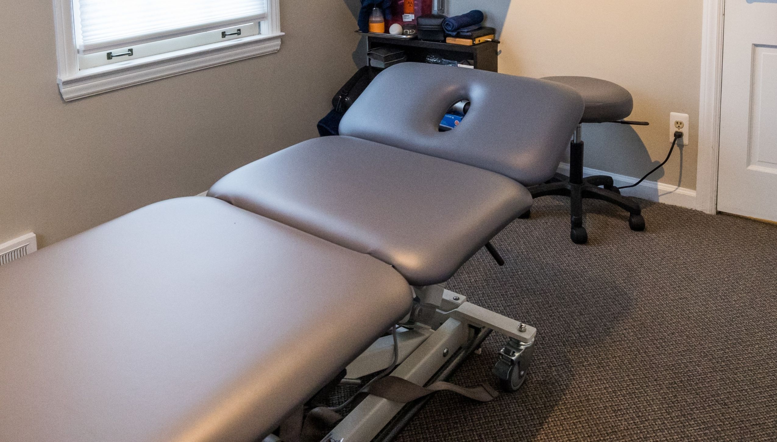 Dr. RJ Burr treating a patient at REACH Rehab + Chiropractic in Plymouth, MI